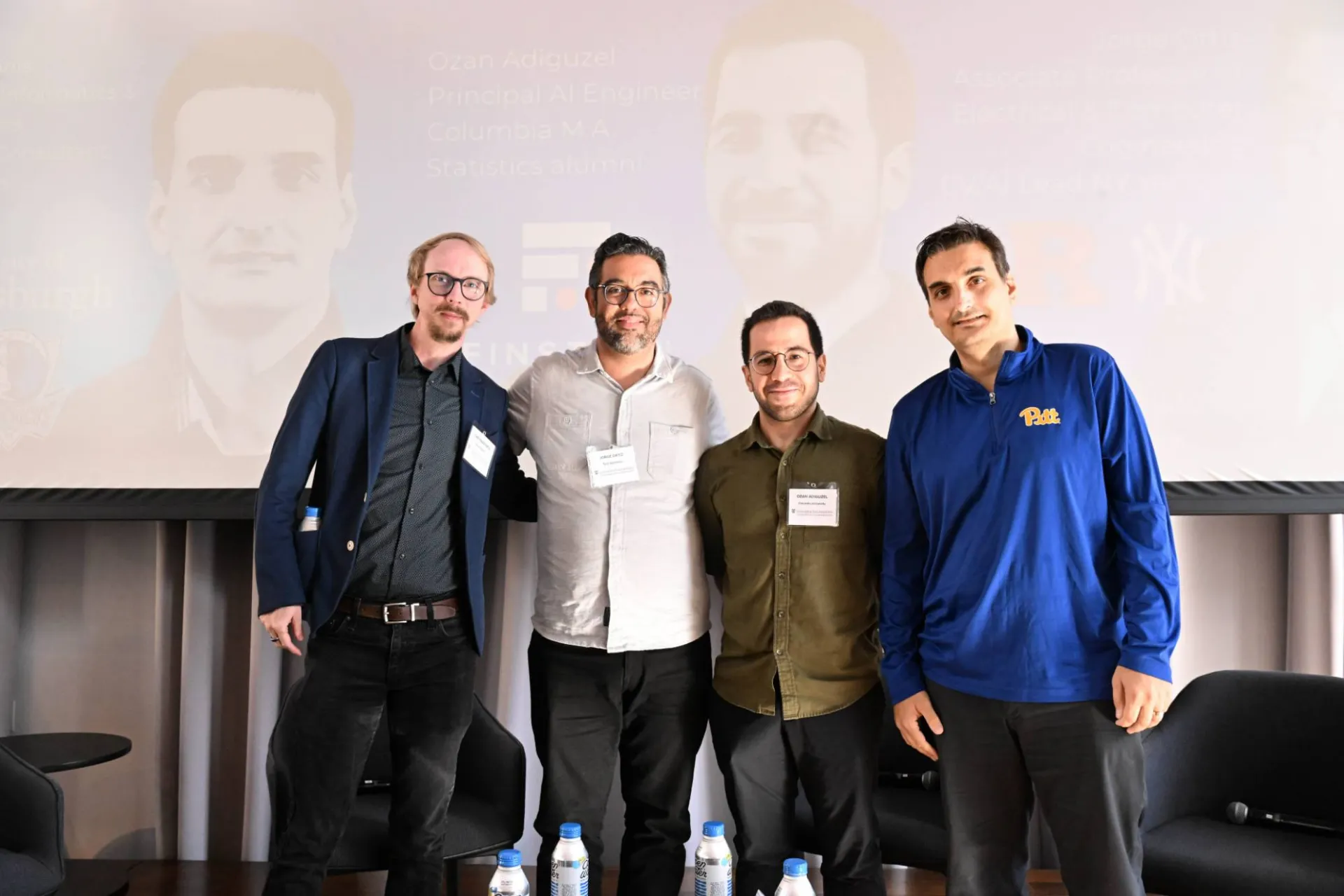 group photo of 4 members on stage