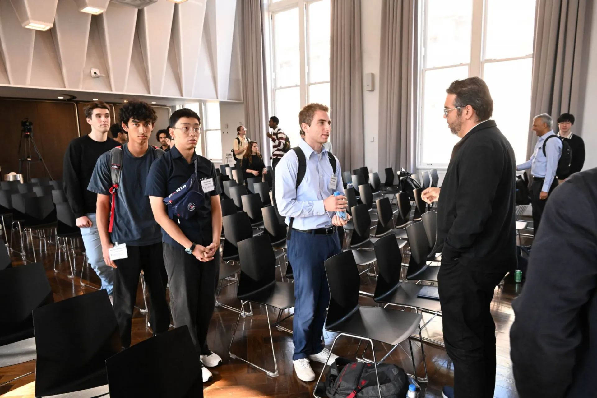 picture of audience members lining up to ask panelists questions