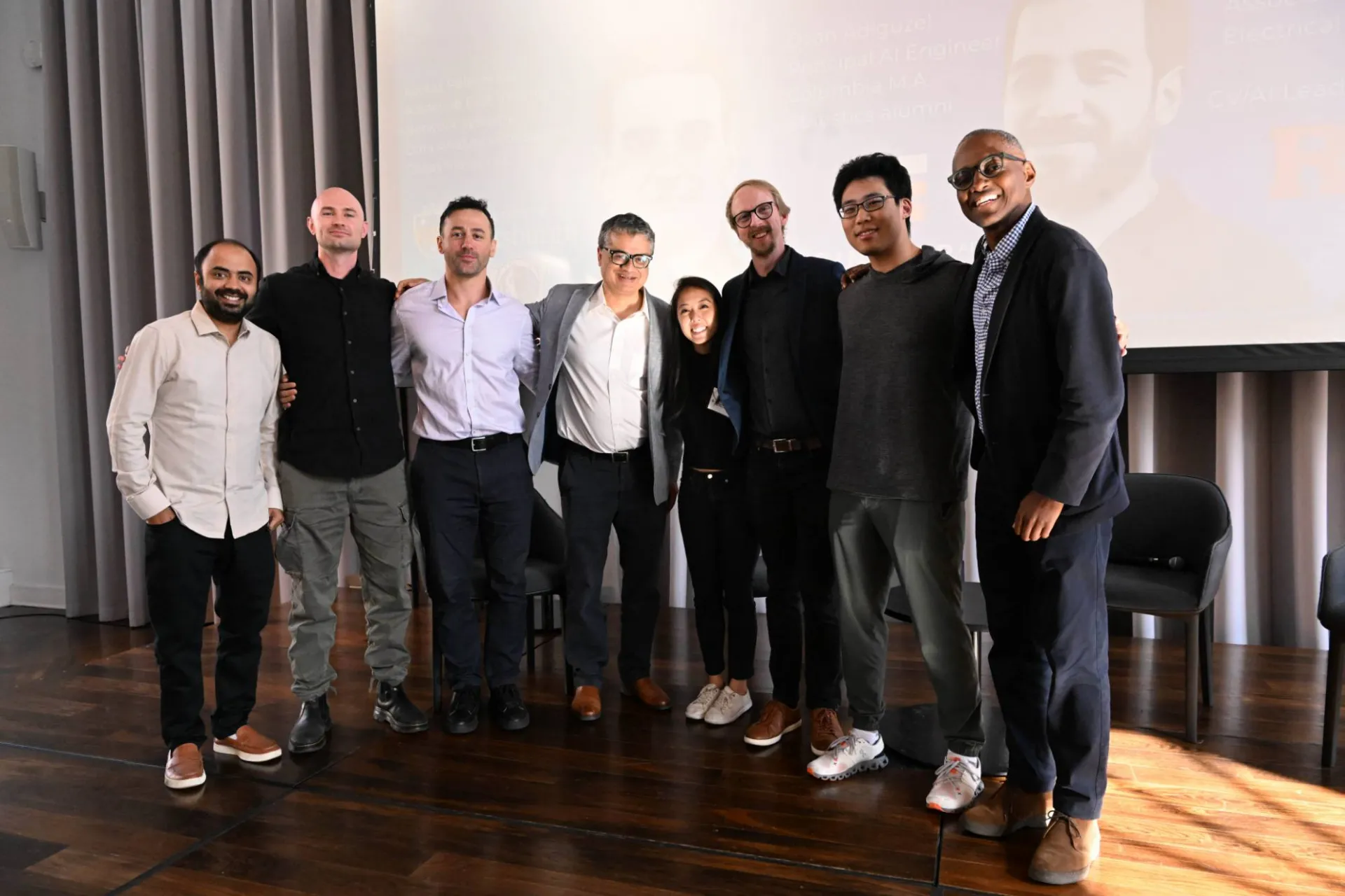 group photo of 8 members on stage